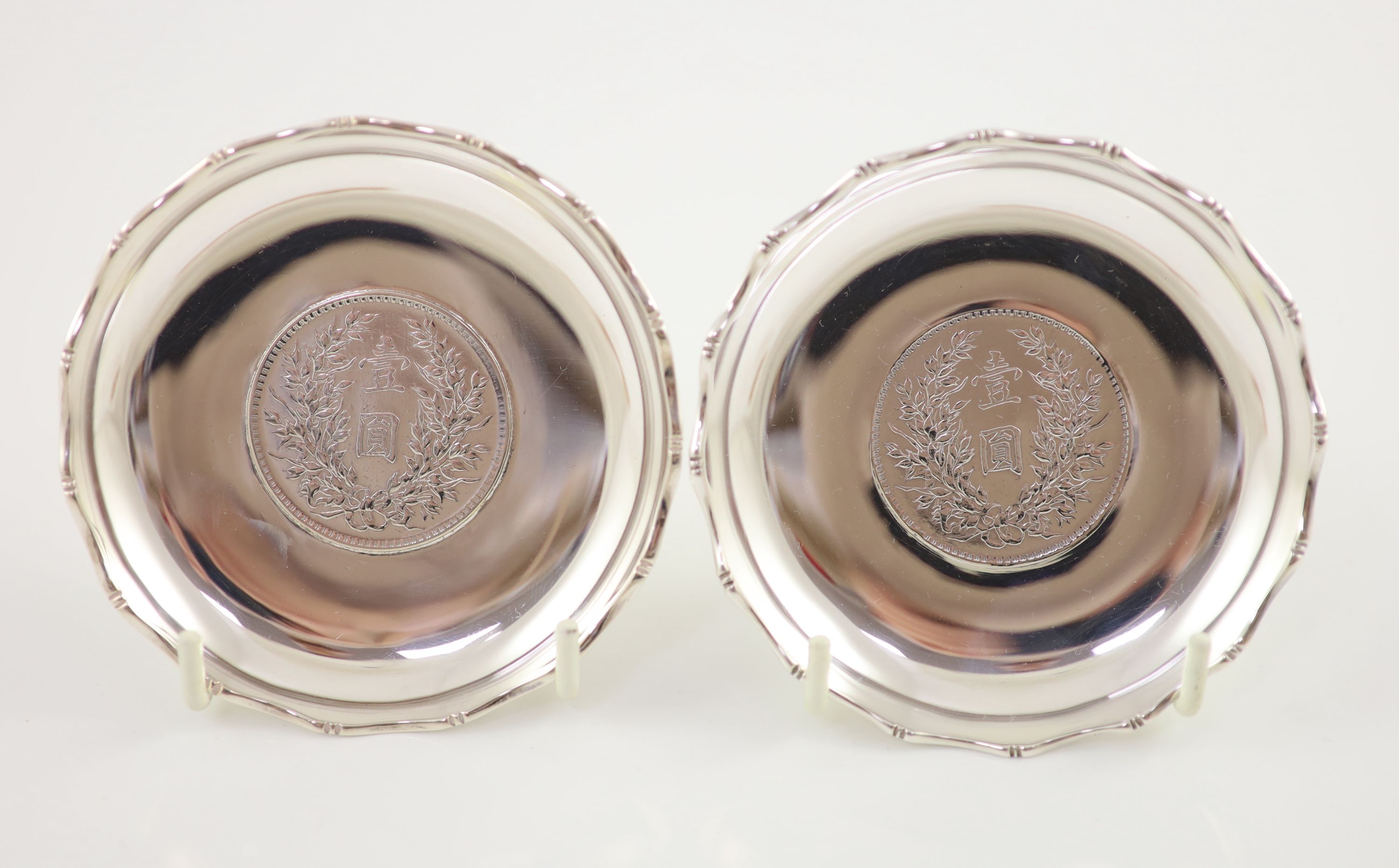 Ten early 20th century Chinese Export small Sterling silver coin inset dishes with shaped 'bamboo' edges, by Tach Hing, Hong Kong,